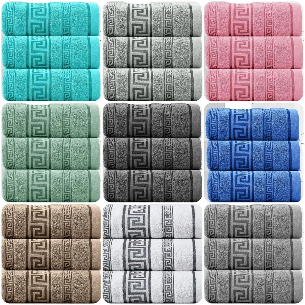 Set of folded towels in various colors with a Greek key pattern.